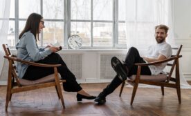 Free 2 Women Sitting on Brown Wooden Chair Stock Photo